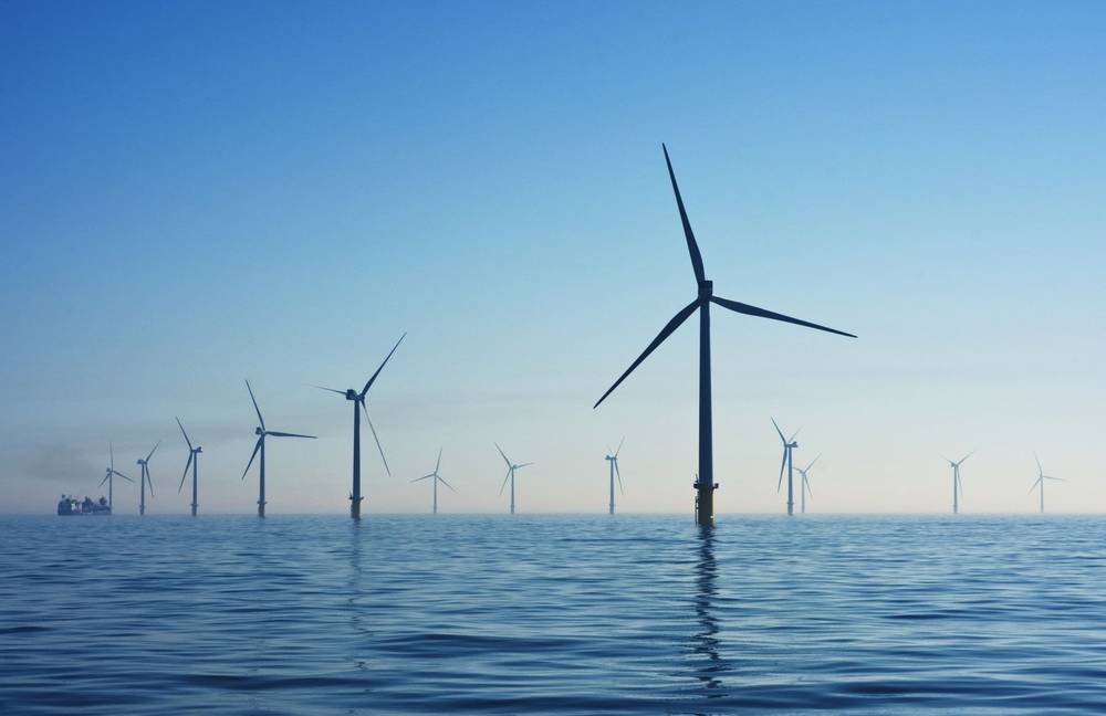 Offshore wind turbines at sea under a clear sky
